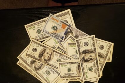 a pile of twenty dollar bills sitting on top of a table
