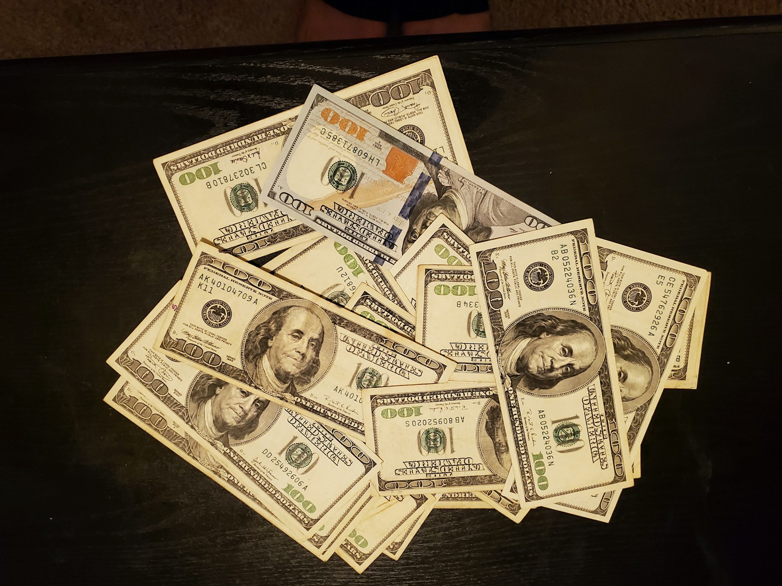 a pile of twenty dollar bills sitting on top of a table