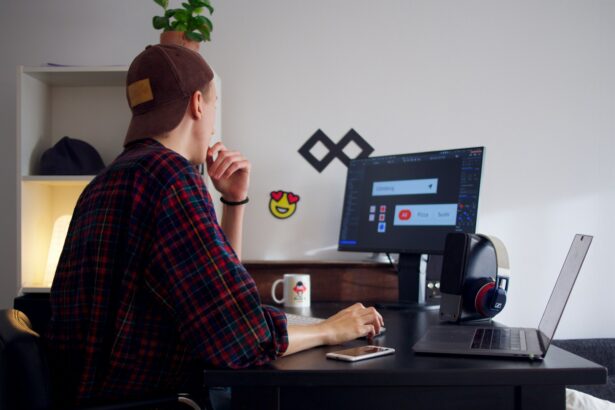 man sitting near table using computer