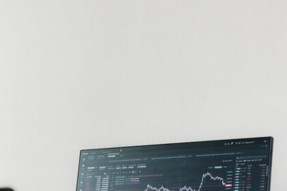 a computer monitor sitting on top of a wooden desk
