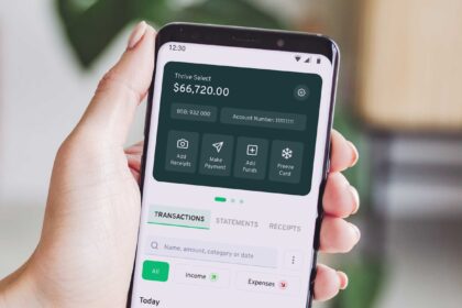 a person holding up a smart phone with an app on the screen