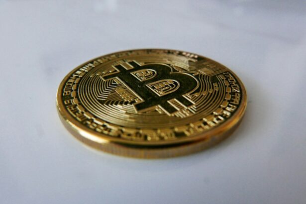 a gold bit coin sitting on top of a white table