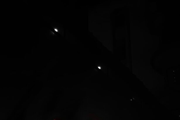 Red emergency sign illuminates a dark building entrance.