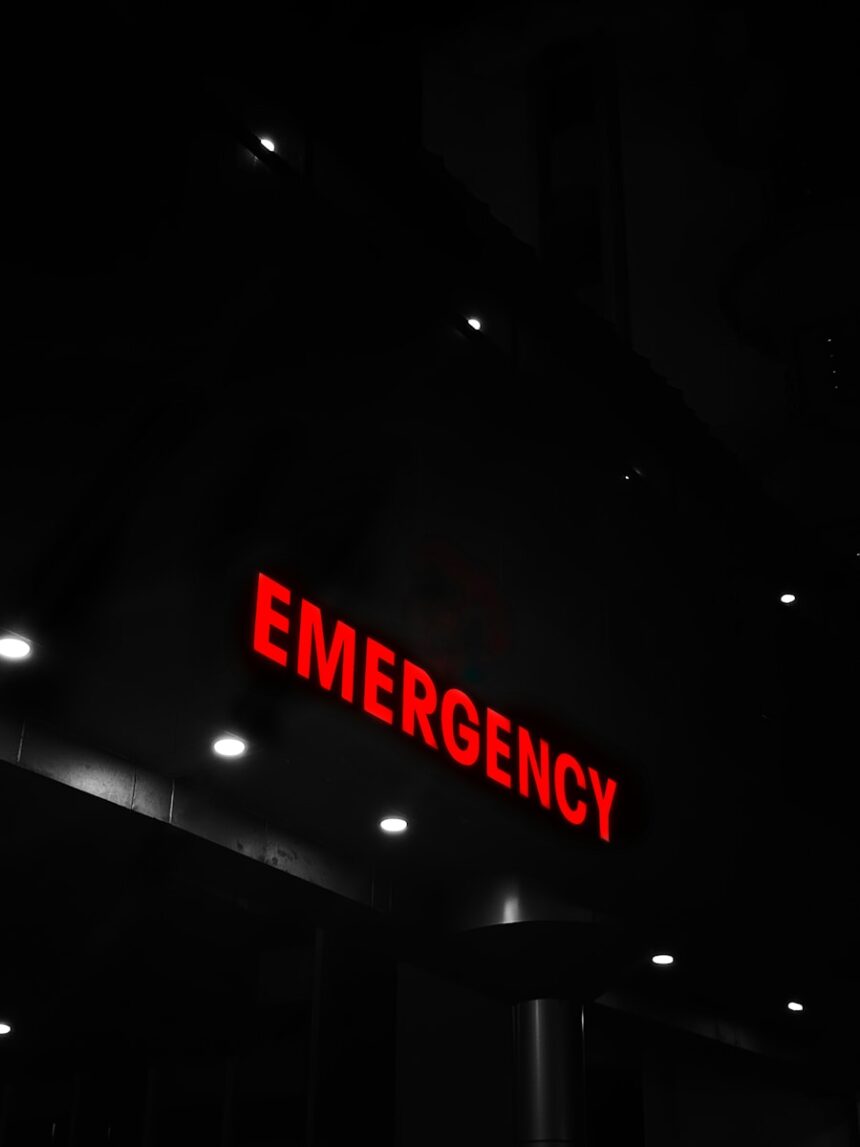 Red emergency sign illuminates a dark building entrance.