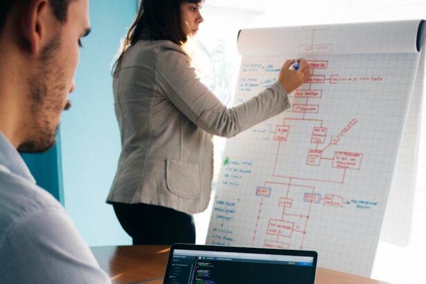 person wearing grey dress shirt beside table