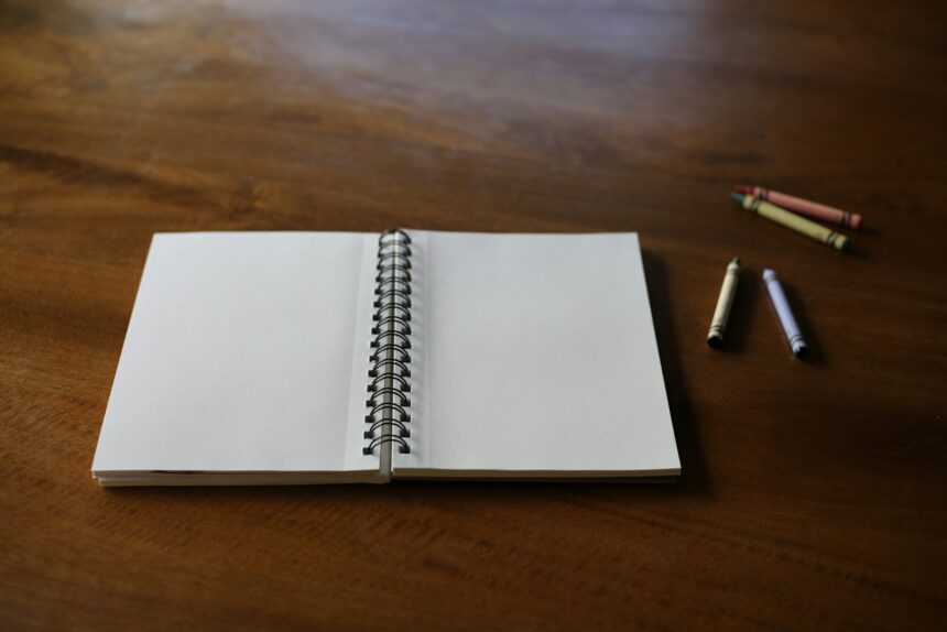 A notebook with a pen on a wooden table