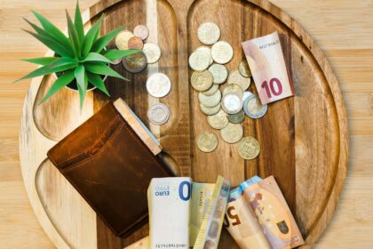 A wooden table topped with lots of money